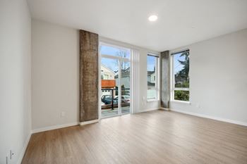A room with a large window and sliding glass doors. at Ion Town Center, Shoreline, WA